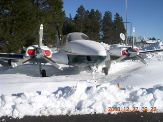 snowy, ice twin-engine airplane at Flagstaff Airport (FLG)