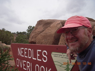 Canyonlands Lathrop hike/run - Adam running with sign
