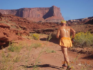 87 7qb. Canyonlands National Park - Lathrop trail hike - Adam running - back (tripod)