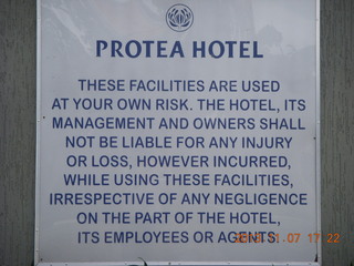 Uganda - Entebbe - Protea Hotel - sign (too many lawyers)