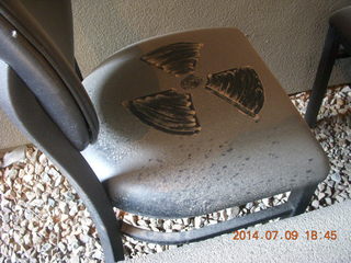 dusty chair with radiation sign cut into the dust
