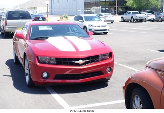 red Chevy in multiple parking spaces
