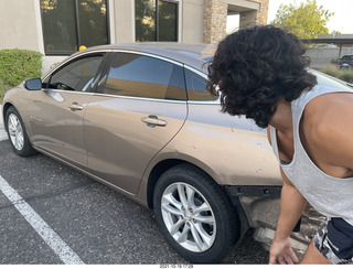 Anthony and his damaged car with new tires